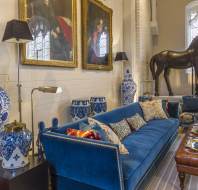 Long comfortable sofa, Victorian parlour styling and large bronze horse