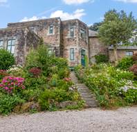 Red brick building with shrubbery and plants