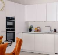 Fitted kitchen with white cupboards