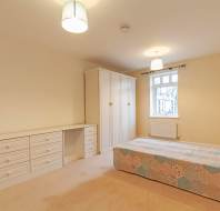 Bedroom with white wardrobes