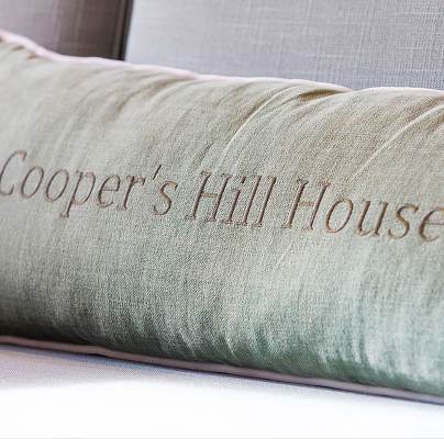 Monogrammed cushion on a plush sofa