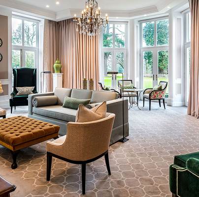 Comfortable chairs and tables by large windows