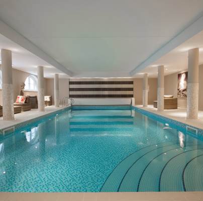 View along indoor pool with mosaic tiles