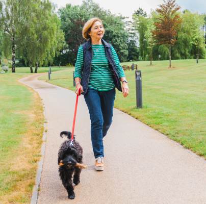 Retirement property owner walking dog