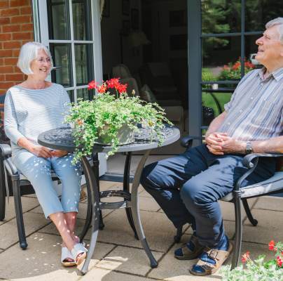 Owners relaxing in their garden