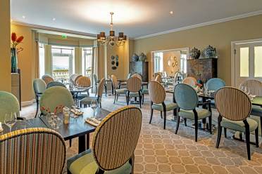 Dining room with a view over the sun terrace at Audley Clevedon Restaurant tables looking out to terrace