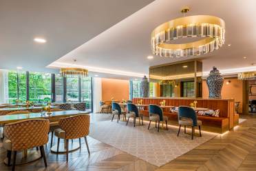 Restaurant with feature lighting and parquet floor