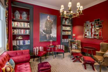 Owners' library at Audley St George's Place Luxury lounge with bookshelves and chandelier