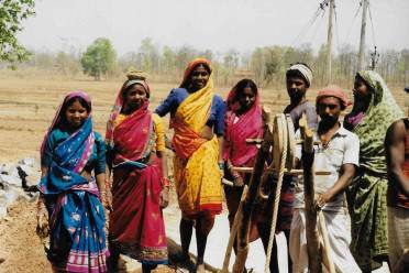 Deepening a well as drought looms People working outdoors in traditional Indian clothing